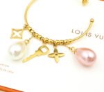 Louis Vuitton Pearl Gold Charm Hoop Earrings - Image 7